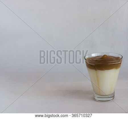 Dalgon Coffee In A Glass Glass On The Table On A Light Background.