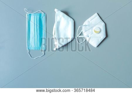 Different Protective Face Masks On Blue Background With Copy Space. Disposable Medical Mask, Facemas
