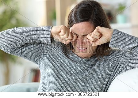 Middle Age Woman Scratching Itchy Eyes Sitting On A Couch At Home