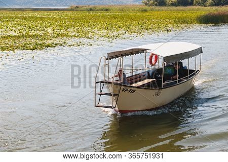 Montenegro, National Park Skadar Lake - September, 21 2018: A Small Boat With Tourists In The Middle
