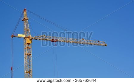 Crane. Construction Crane. Huge Crane Against Blue Sky. Self-erection Cranr. Tower Crane.