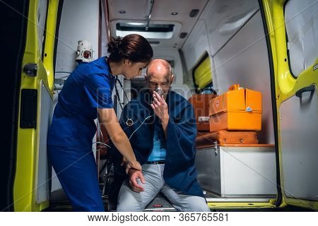 A Paramedic Is Checking The Hand Of A Man Rescued From The Fire, There Might Be A Fracture