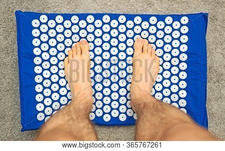 Male Foot On Acupuncture Rug. Alternative China Medicine.