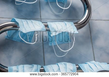 Facemasks Drying On The Coil. Double-use Of Protective Mask. Saving Money On Mask Double-usage. Usin