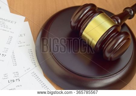 Justice Mallet And Many Supermarket Receipts On Wooden Table