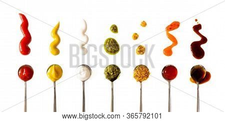 Ketchup, Mustard, Mayonnaise, Basil Pesto, Sweet Chili Sauce And Teriyaki Soy Sauce In Spoon Isolate