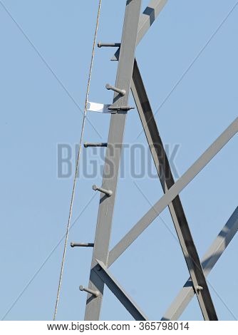High-voltage Electricity Pylon Against Blue Sky With Lightning Rod, The Netherlands
