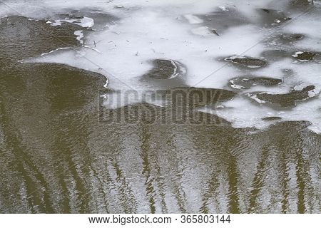 Eroded And Melting Ice Covers The Surface Of The Spring River