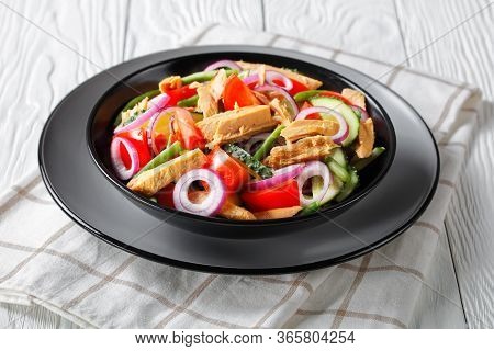 Healthy Canned Tuna Salad With Tomatoes, Cucumber, Red Onion And Green Bean Served On A Black Plate 