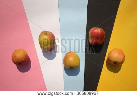Top View Of Apples On Colorful Paper Sheets