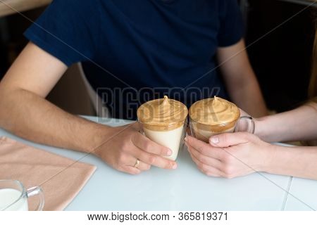 A Man And A Woman In The Kitchen Are Making Dalgon Coffee, Whipped With A Mixer. The Process Of Maki