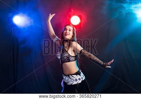 Girl Dancing Belly Dance, Fusion Or Tribal. A Woman In A Beautiful Costume Demonstrates Charming And