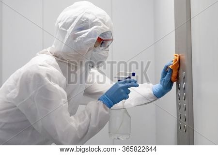 Concept Coronavirus Disinfection. People In Hazmats Making Cleaning In Lift Apartment