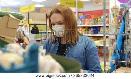 Woman Buyer Wearing A Protective Mask.shopping During The Pandemic.emergency To Buy List.panic Buyin