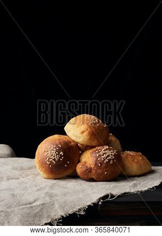 Baked Round Bun With Sesame Seeds, Black Background, Home Baking, Copy Spave
