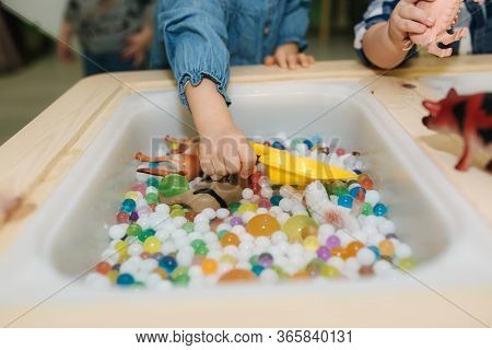 Close-up Of Kids Take Orbeez From Water