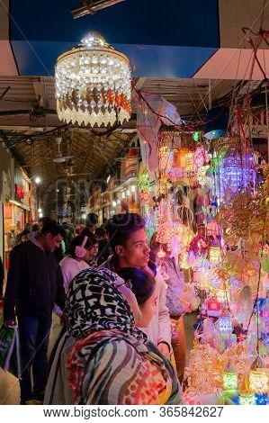 Kolkata, West Bengal, India - 29th December 2019 : Buyers Chekcing Out Goods From Illuminated Shop, 