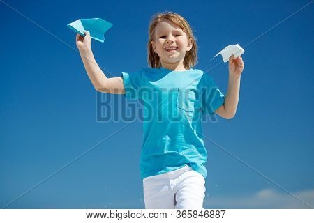Child Boy Plays At Sea With An Airplane. Dream To Travel.