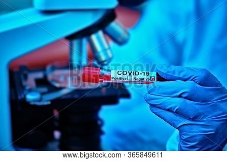 COVID-19. Doctor, microbiologist, scientist in a protective suit, makes a research on blood samples of infected people in the laboratory. Coronavirus test.