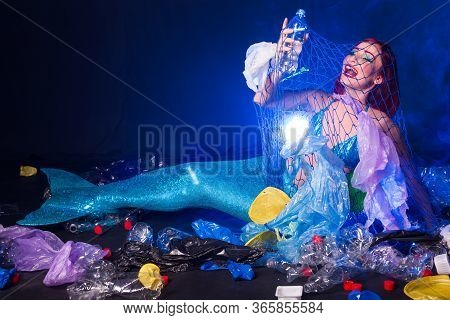 Ocean Plastic Pollution Concept. Mermaid Lives To Polluted Habitat.