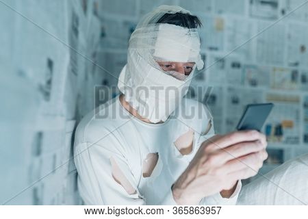 Victim Of Tabloid Journalism And Fake News Infodemic, Conceptual Image Of Man Wrapped In Bandages Su