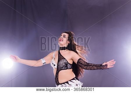 Girl Dancing Belly Dance, Fusion Or Tribal. A Woman In A Beautiful Costume Demonstrates Charming And