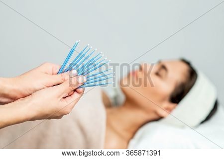 Eyelash Extension Disposable Microbrushes, Eyelash Cotton Swabs In Hands On Backgrond Of Patient, Cl