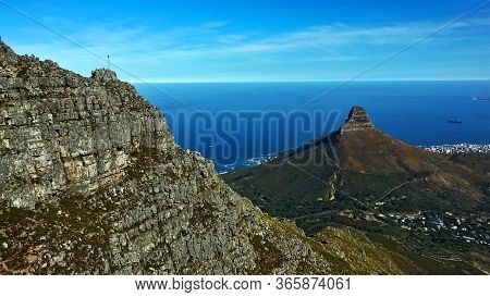 Cape Town Against The Background Of The Blue Atlantic Ocean, A Cliff Of An Unusual Shape Is Clearly 