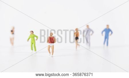 Miniature People Running On White Background, Healthy Concept