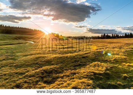 Rural Grassland Landscape In Sunny Spring Evening. Sunset In Jizerka Village With Jizerka River, Jiz
