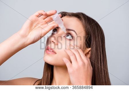 Close-up Portrait Of Her She Nice Attractive Lovely Pretty Brown-haired Girl Applying Eye Drops Pres