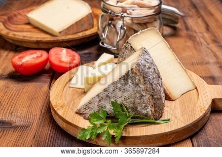 Pieces Of Cheese Tomme De Montagne Or Tomme De Savoie Made From Cow Milk In French Alps.