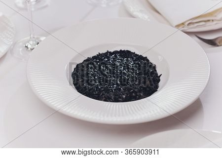 Delicious Italian Risotto With Cuttlefish Ink Squid-ink . Black Risotto. Healthy Tasty Food.