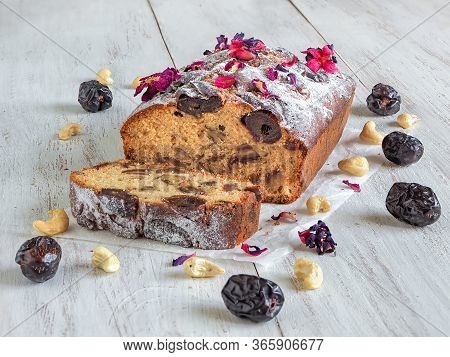 Honey And Date Cake On A White Wooden Table.