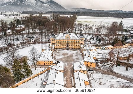 Aerial View Of Schloss Hellbrunn Covered In Snow View Of Snow Mountain Untersberg Near Salzburg Outs