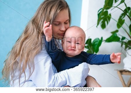 Mom Hugs Crying Moody Kid Tantrum. Little Baby Child On Mother Hands. Family Life, Motherhood