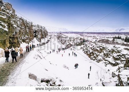 Silfra, Iceland-Feb 19, 2020: Toursts on Silfra rift during winter, the place where Eurasian and the American tectonic plate are divided in Thingvellir National Park, Iceland. 