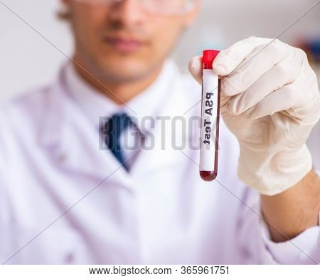 Young handsome lab assistant testing blood samples in hospital