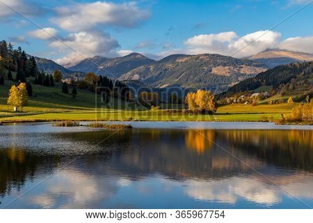 autumn pond under the mountains, Murau district,
Styria, Austria