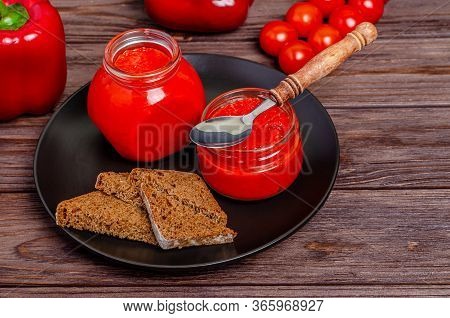 Ajvar Or Pindjur Red Vegetable Spread Pepper Mousse From Paprika And Tomatoes In Glass Jars In A Bla