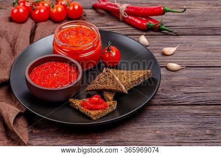 Ajvar Or Pindjur Red Vegetable Spread Or Pepper Paprika And Tomato Mousse In A Clay Bowl And Glass J