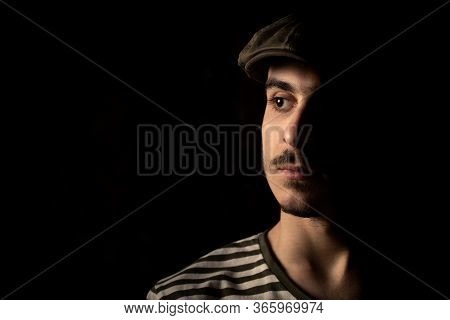 Portrait Of Cute Young Guy With Moustache And A Hat On Black, Dark Background. Copy Space, Space For
