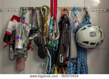 Screwgate Carabiner Attached To A Nylon Sling With A Bunch Of Climbing Gears On The Background