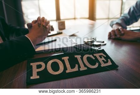 Tense Situation At The Inquiry Room Where Police Officers And The Accused Are Talking.