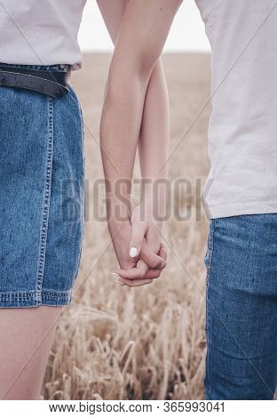 Lovers In Wheat Hold Hands 
Boy And Girl Hold Hands White Manicure For A Girl In Love With Jeans