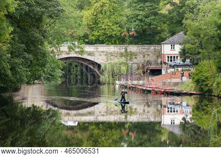 Knaresborough, Uk - September 20, 2022. Man In A Wetsuit Kneeling On A Paddle Board On The River Nid