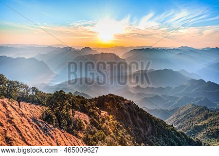 Landscape Images Of Morning Sun And Ligh White Mist Covering The Mountain Peaks Are Complex. To Natu