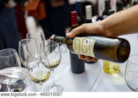 Wine. Glass Of Wine. Hands Serving Bottles Of Wine In Transparent Glasses For Guests. Toast. Celebra