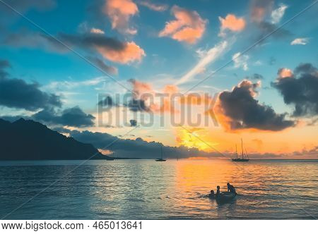 Multi Colored Tropic Sunset Over Calm Sea Water. Yacht Boats Silhouette Against Blue Orange Clouds I