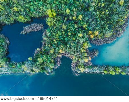 Aerial View Of A Forest Lake. Aerial View Of Blue Lake And Green Forests On A Sunny Summer Day. Dron